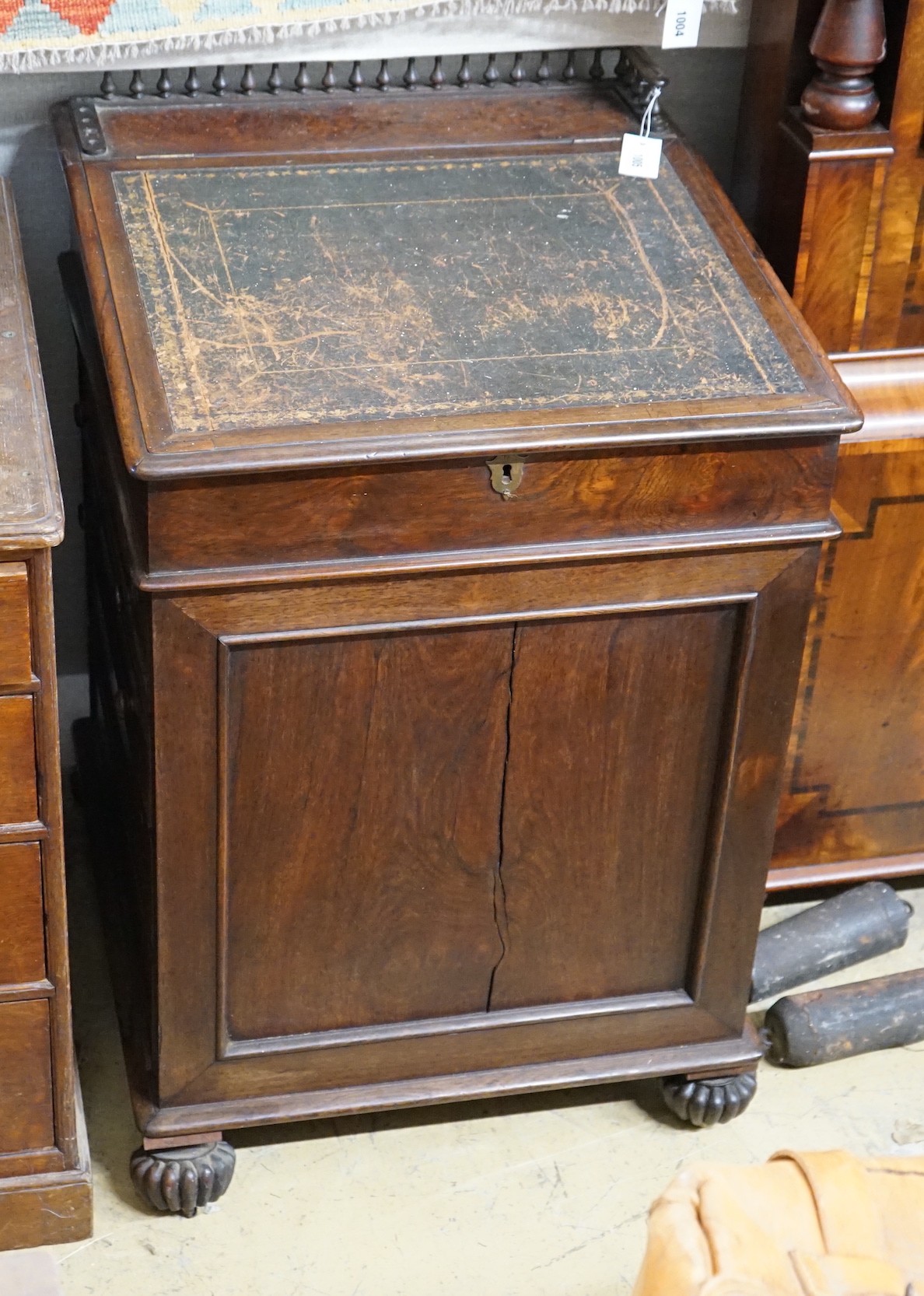 A William IV rosewood Davenport with sliding top, width 60cm, depth 64cm, height 89cm